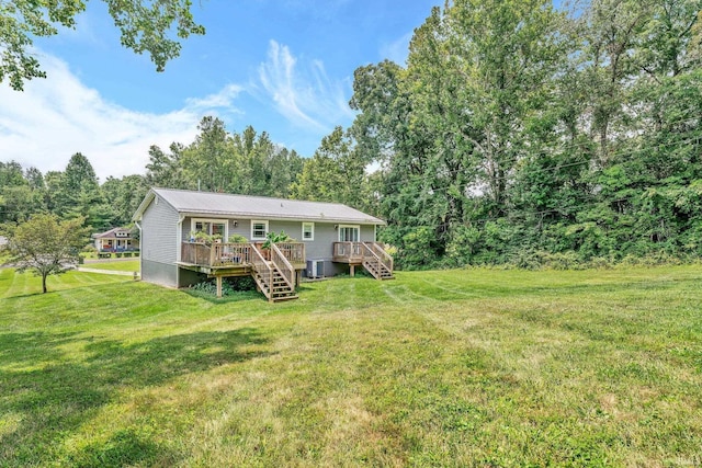 rear view of property featuring a deck, cooling unit, a yard, and stairway