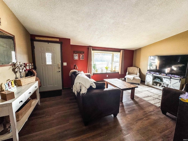 living room with a textured ceiling and wood finished floors