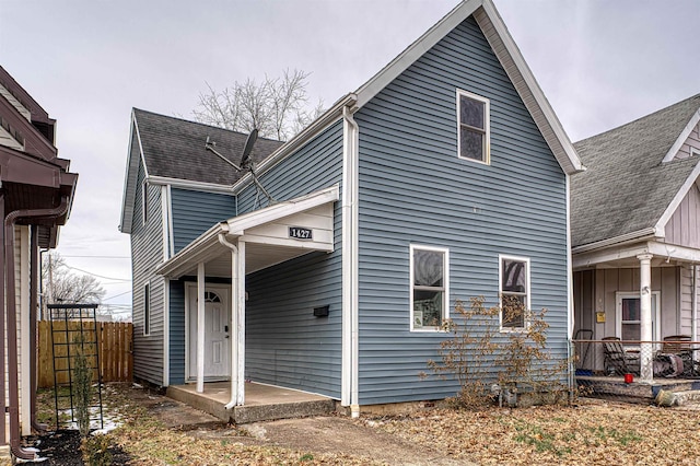 rear view of property with fence