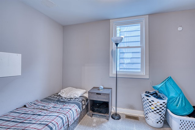 carpeted bedroom with baseboards and visible vents