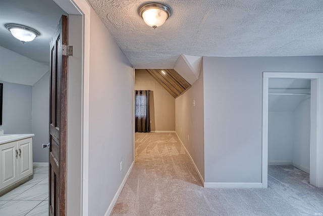 additional living space with lofted ceiling, baseboards, and a textured ceiling