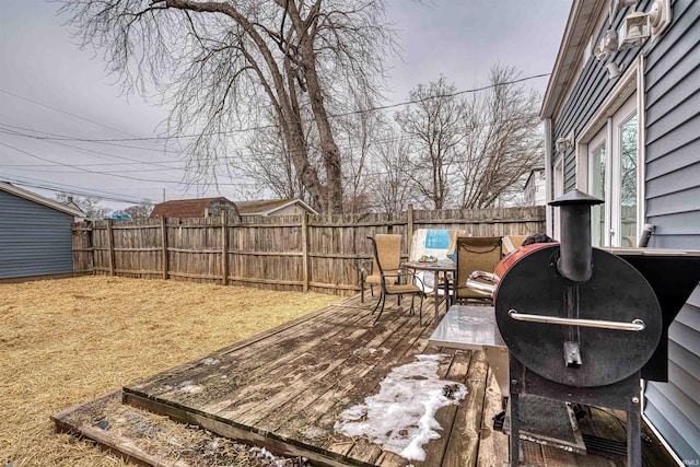 deck with a fenced backyard and outdoor dining area