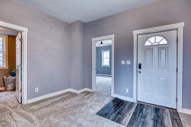 carpeted foyer entrance with baseboards