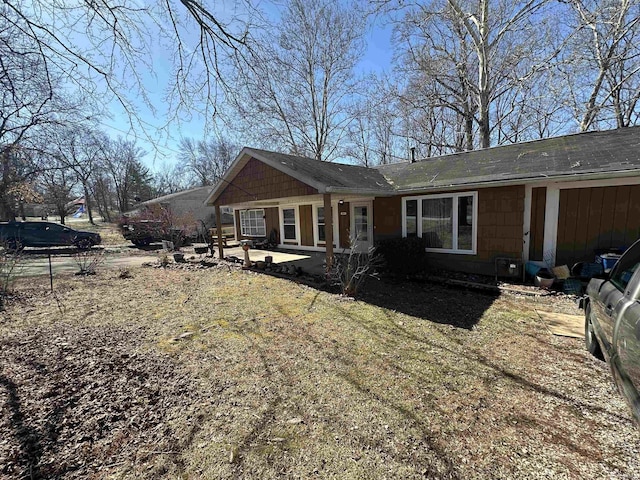 back of property with a patio area and a yard