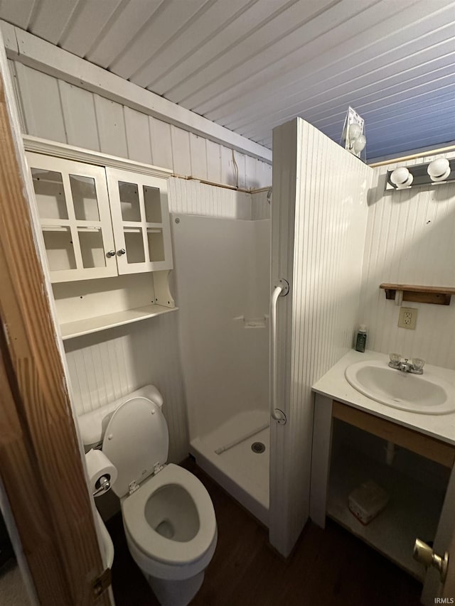 full bathroom featuring vanity, wood finished floors, a shower stall, and toilet