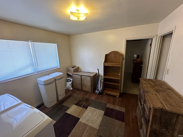 interior space featuring laundry area, dark wood finished floors, and washer and clothes dryer