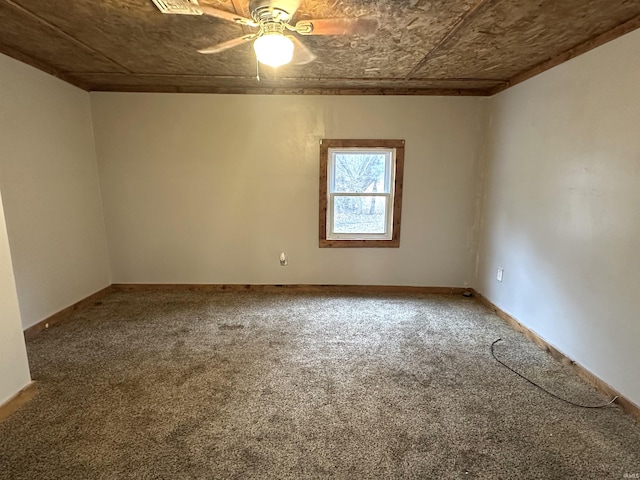 carpeted empty room with an ornate ceiling, baseboards, and a ceiling fan