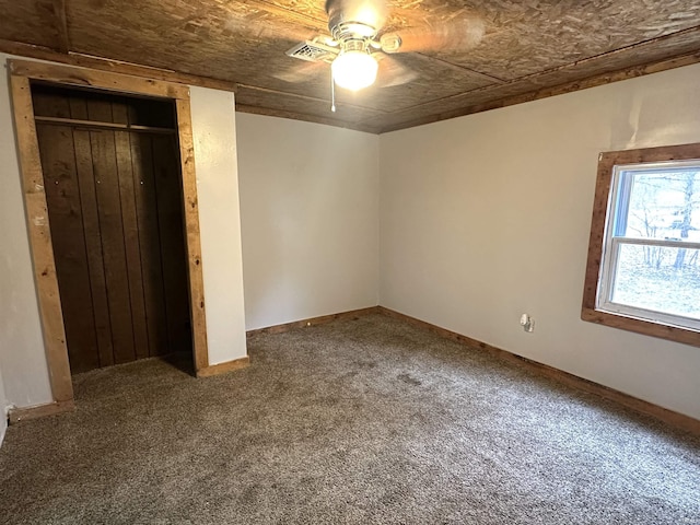 unfurnished bedroom with carpet, a closet, visible vents, a ceiling fan, and baseboards