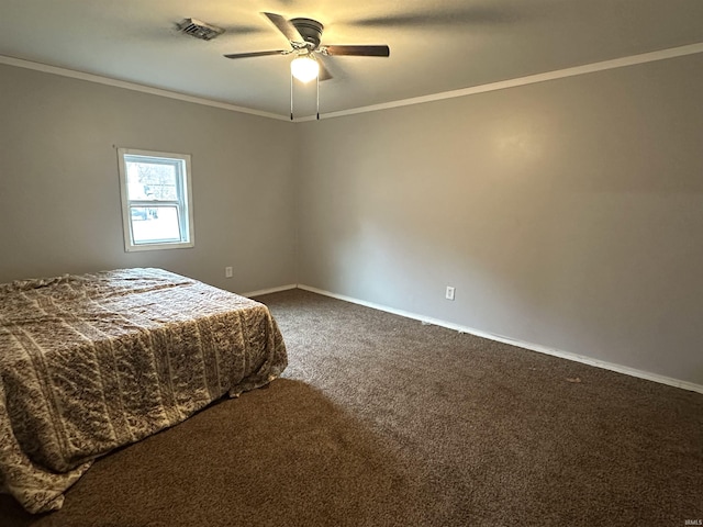 unfurnished bedroom featuring carpet, visible vents, ornamental molding, ceiling fan, and baseboards