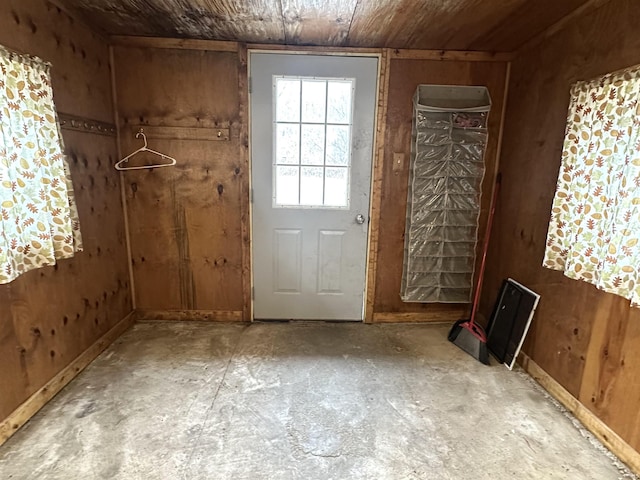 doorway featuring wood walls and wood ceiling