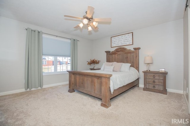 bedroom with light colored carpet, ceiling fan, and baseboards