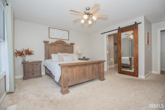 bedroom with a barn door, visible vents, baseboards, a ceiling fan, and light colored carpet