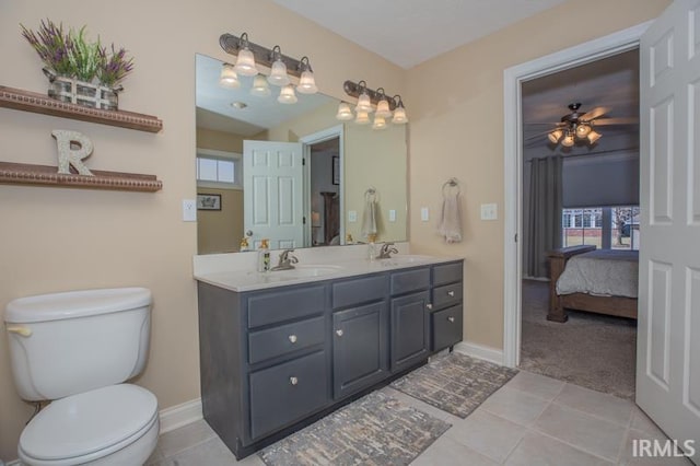 full bathroom featuring toilet, a wealth of natural light, and a sink