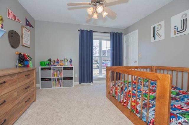 bedroom with light carpet and ceiling fan