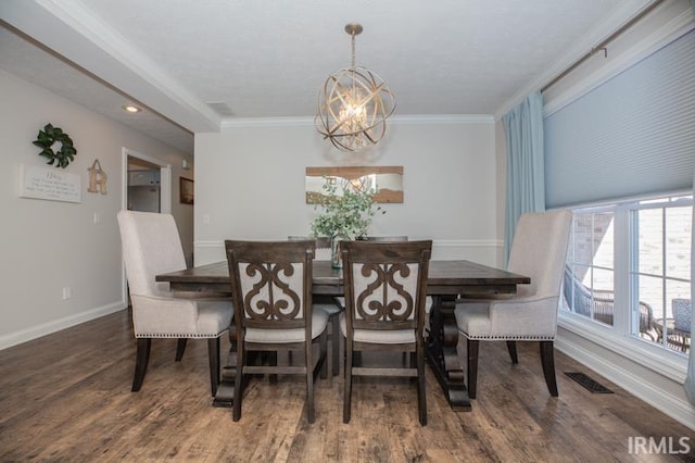 dining space with dark wood-style floors, visible vents, crown molding, and an inviting chandelier