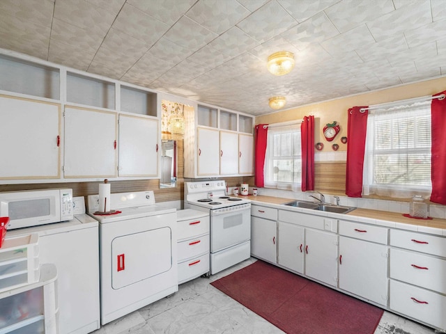 kitchen with white appliances, a sink, white cabinets, marble finish floor, and light countertops