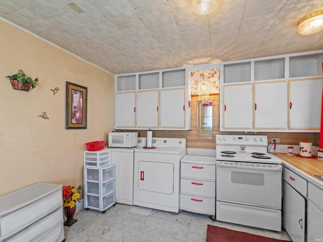 kitchen with marble finish floor, washing machine and clothes dryer, light countertops, white cabinets, and white appliances