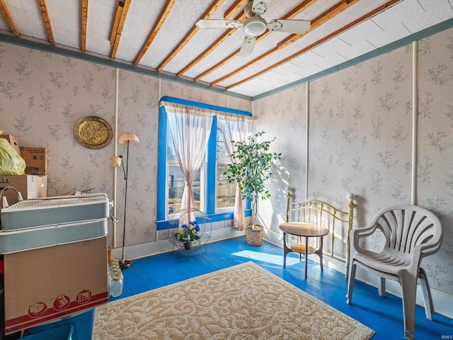 unfurnished room featuring wallpapered walls, baseboards, dark wood finished floors, and a ceiling fan