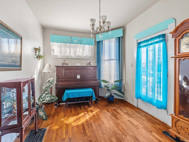 living area featuring wood finished floors and a notable chandelier