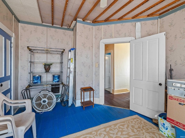 interior space with dark wood-type flooring and wallpapered walls