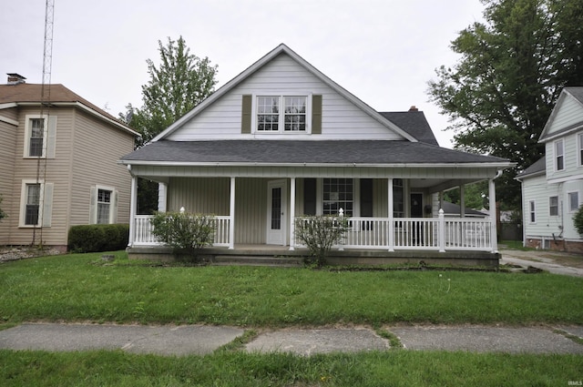 farmhouse featuring covered porch, roof with shingles, and a front yard