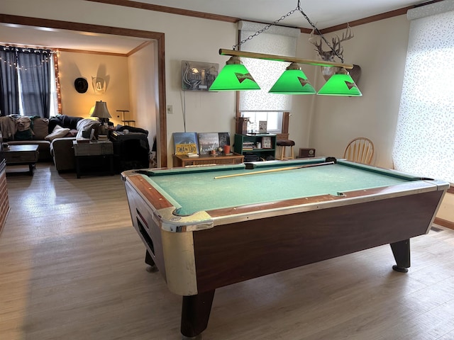 recreation room with ornamental molding and wood finished floors