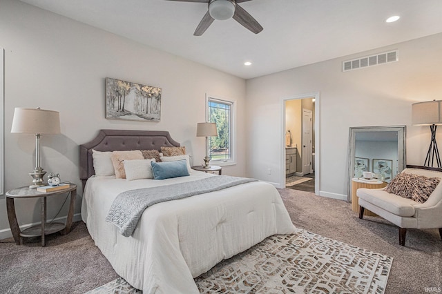 carpeted bedroom with ensuite bathroom, recessed lighting, visible vents, and baseboards