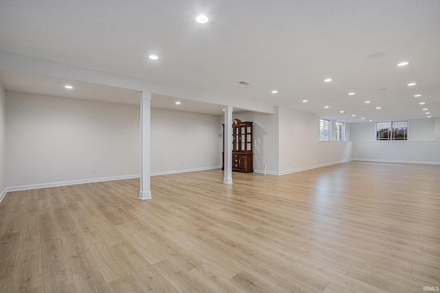 basement featuring light wood-style floors, recessed lighting, and baseboards