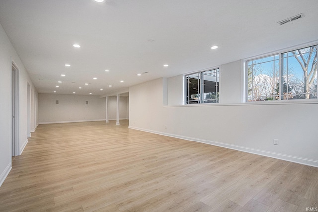 basement with recessed lighting, visible vents, and light wood-style floors