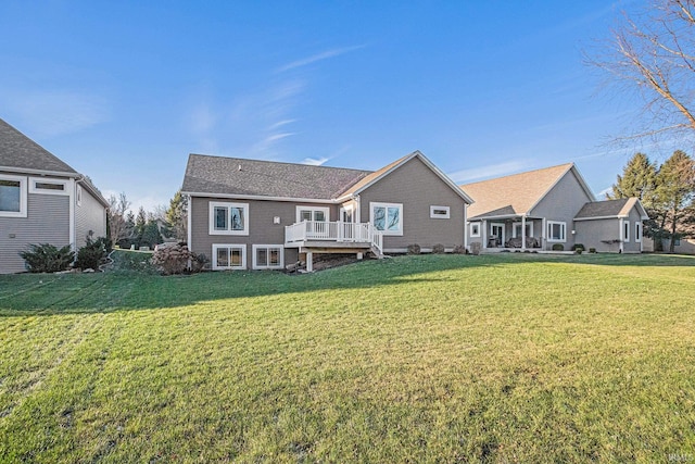 rear view of property with a deck and a lawn