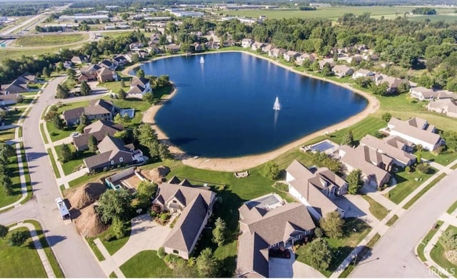 drone / aerial view featuring a water view and a residential view