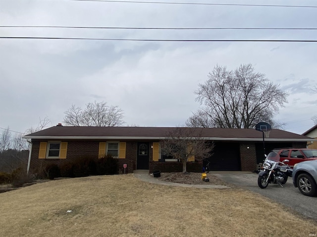 single story home featuring a garage, a front yard, aphalt driveway, and brick siding