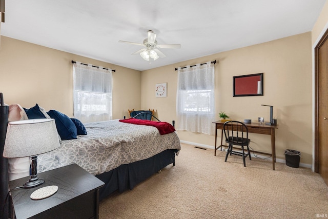 carpeted bedroom with multiple windows, visible vents, and baseboards