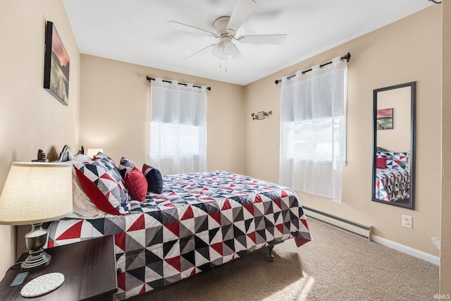 bedroom featuring a baseboard heating unit, carpet floors, a ceiling fan, and baseboards