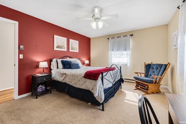 bedroom featuring a baseboard heating unit, ceiling fan, light colored carpet, and baseboards