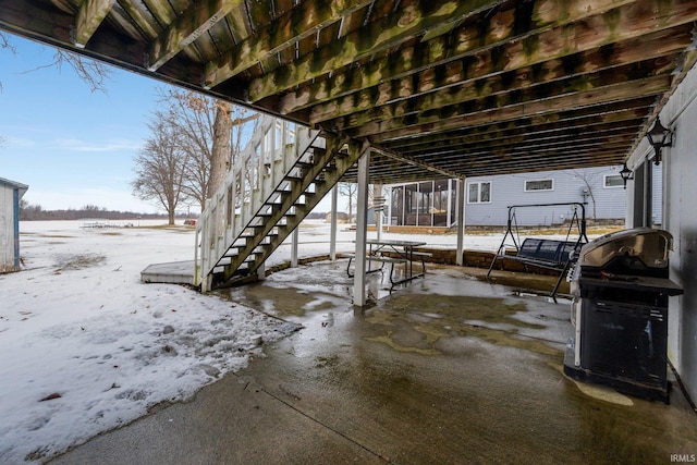 snow covered patio with stairway