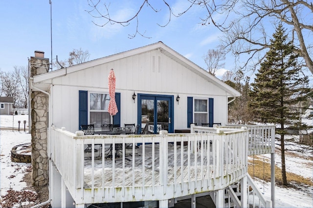 view of front of property with a chimney and a deck