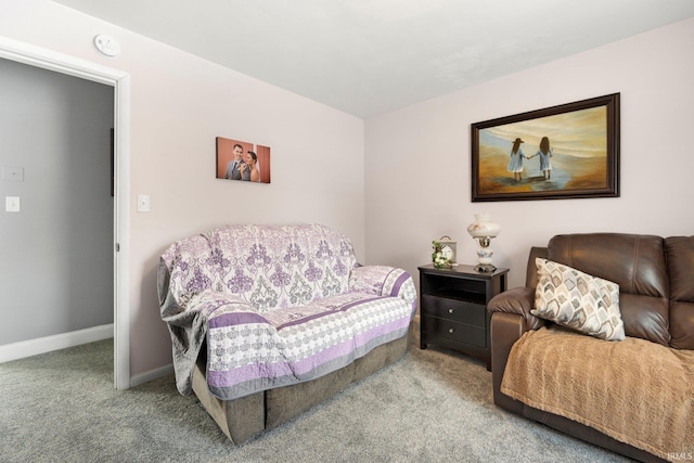 carpeted living room with baseboards