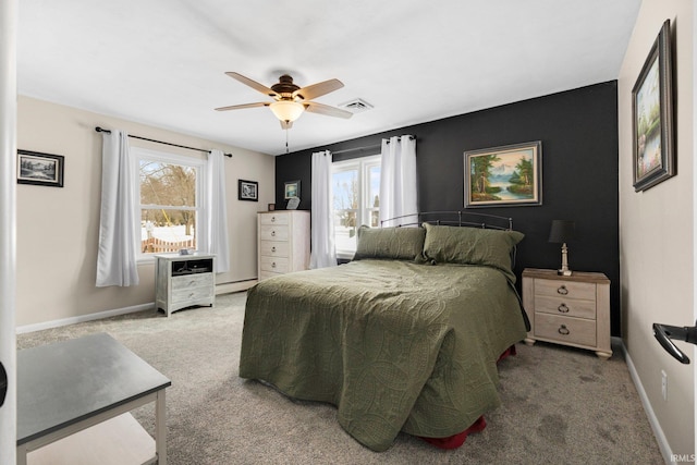 bedroom featuring carpet, visible vents, a baseboard heating unit, ceiling fan, and baseboards