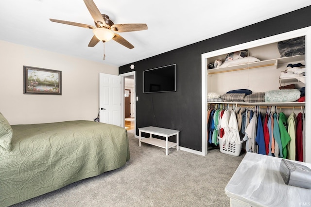 carpeted bedroom featuring ceiling fan and a closet