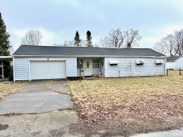 single story home featuring an attached garage, driveway, and a front yard