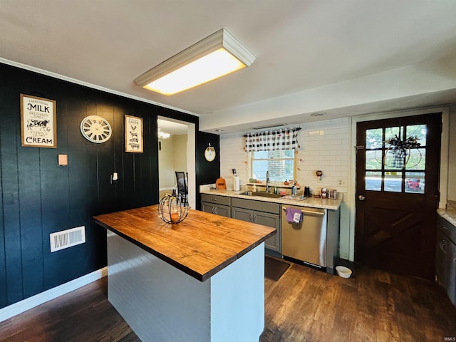 kitchen featuring dark wood-type flooring, a sink, wood counters, visible vents, and dishwasher