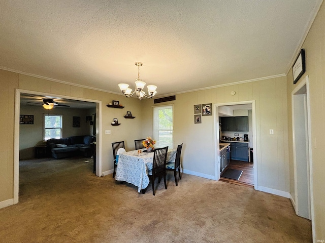 dining area featuring carpet floors, plenty of natural light, and ornamental molding