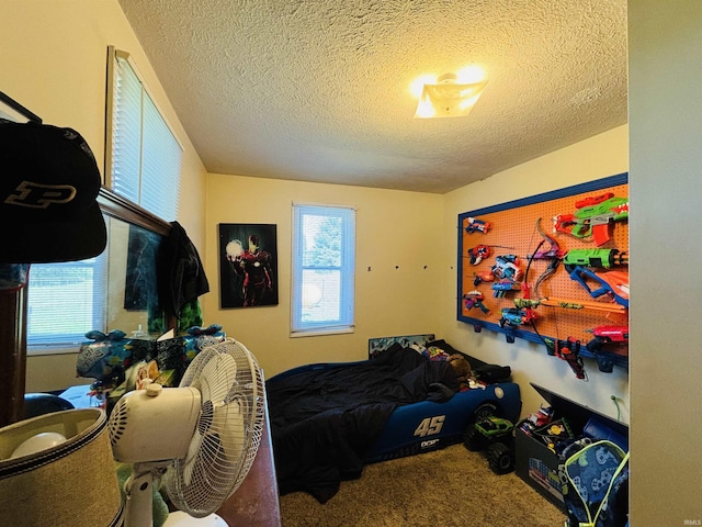 bedroom featuring carpet and a textured ceiling