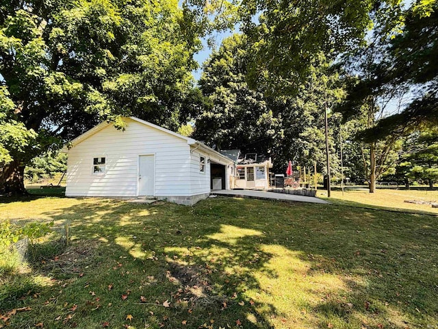 view of yard with a garage and an outdoor structure