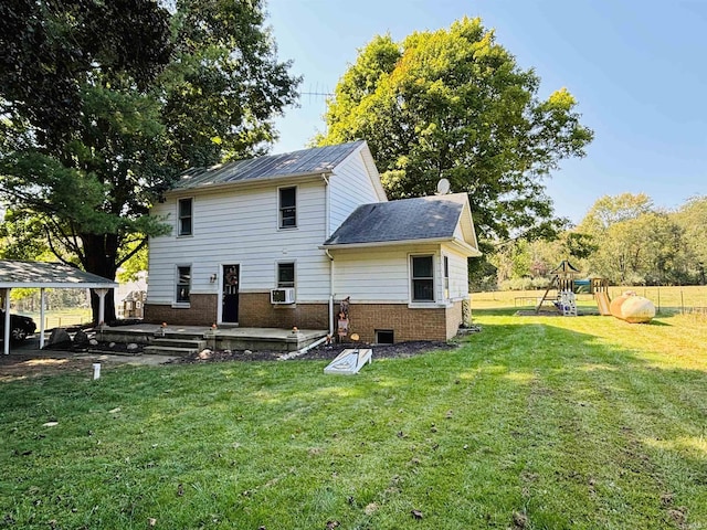 back of property with fence, cooling unit, a yard, a playground, and brick siding