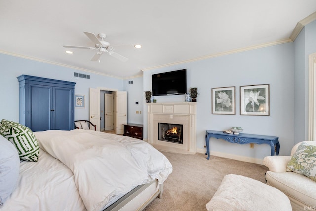 carpeted bedroom featuring a fireplace with flush hearth, visible vents, ceiling fan, and crown molding