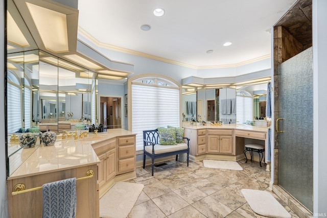 bathroom featuring ornamental molding, two vanities, a sink, and a shower stall