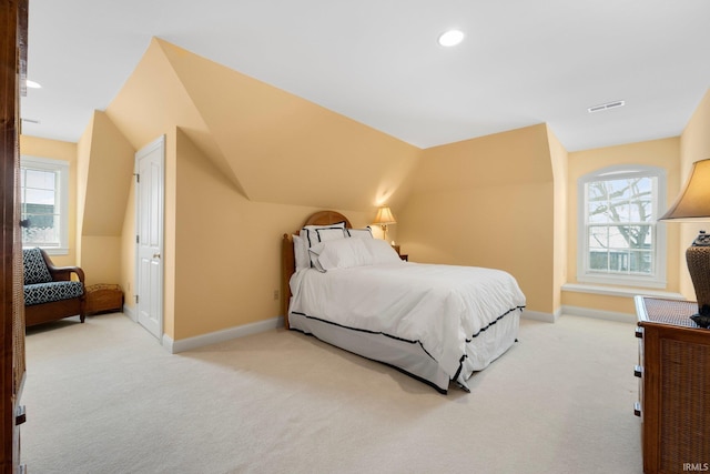 bedroom featuring baseboards, multiple windows, visible vents, and light colored carpet