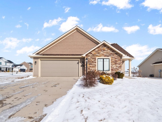 view of front of home with a garage, stone siding, and driveway